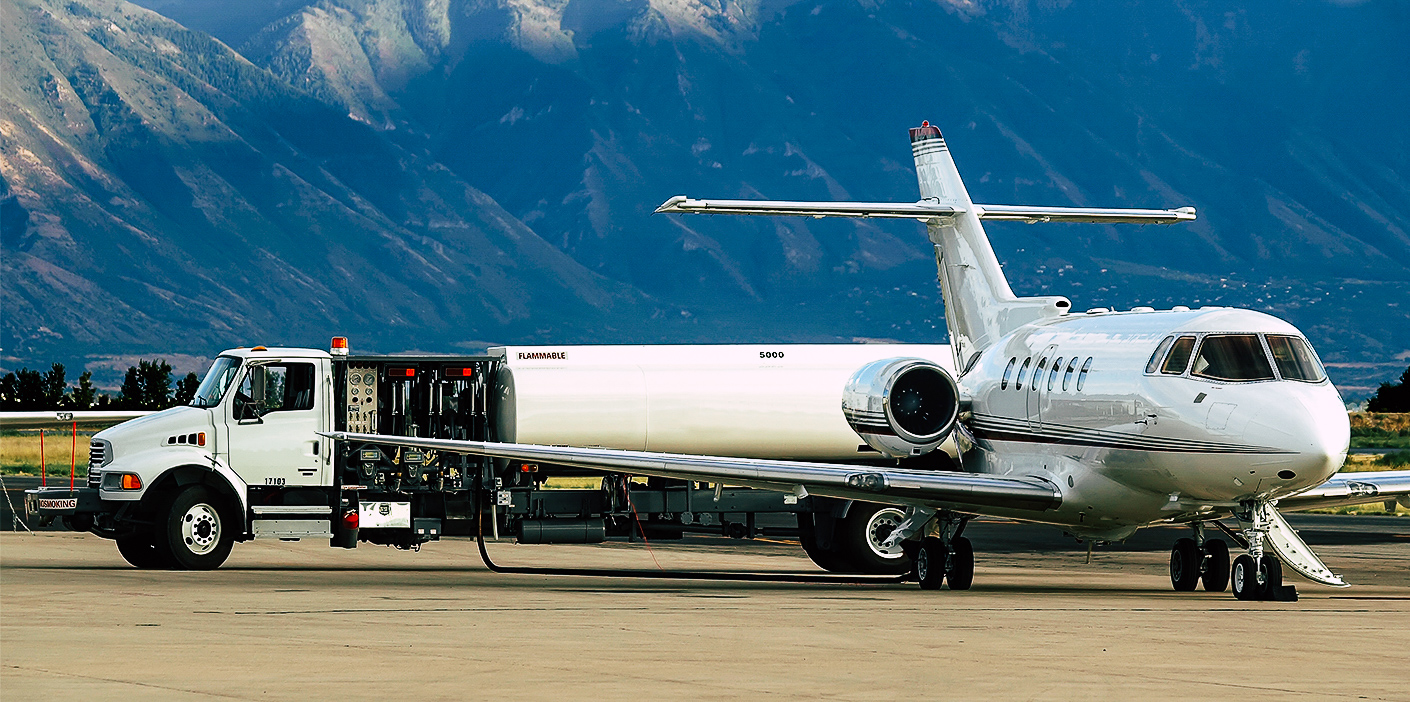 Refueling truck sending fuel to plane