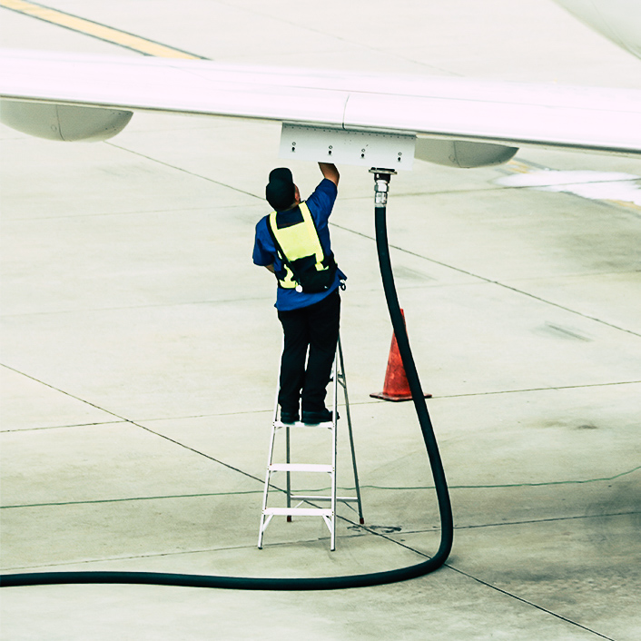 Technician fueling aircraft